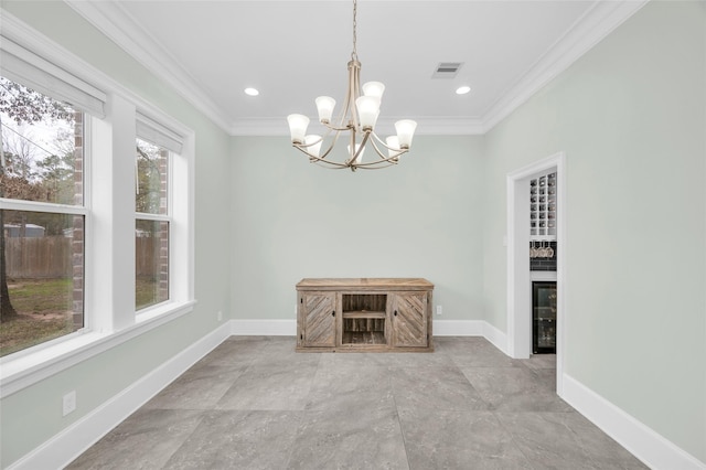 unfurnished dining area with beverage cooler, ornamental molding, and a chandelier