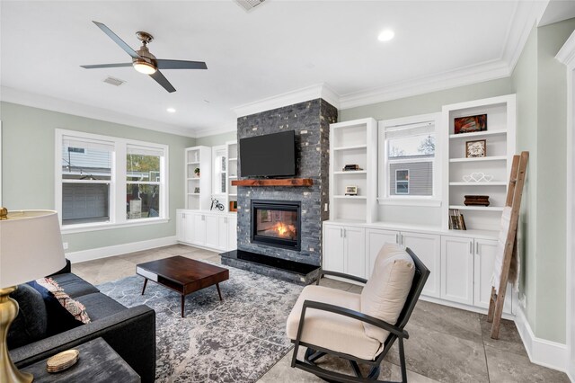 tiled living room with a large fireplace, ceiling fan, ornamental molding, and built in features