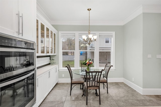 tiled dining space featuring an inviting chandelier and ornamental molding