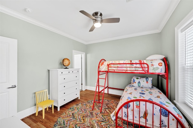 bedroom featuring ceiling fan, hardwood / wood-style floors, and crown molding