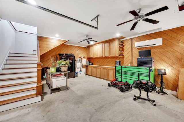 interior space featuring wooden walls, a wall mounted AC, and ceiling fan