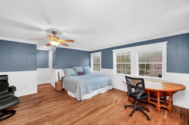 bedroom with crown molding, light hardwood / wood-style flooring, and ceiling fan