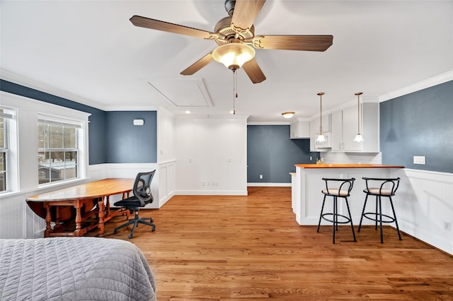 bedroom with light hardwood / wood-style flooring and crown molding