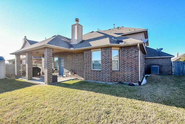 back of house featuring cooling unit, a lawn, and a patio