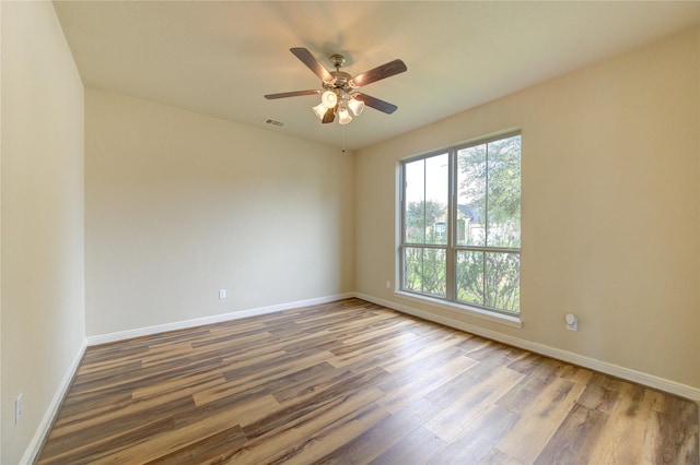 spare room with wood-type flooring and ceiling fan