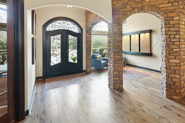 foyer with light wood-type flooring and french doors