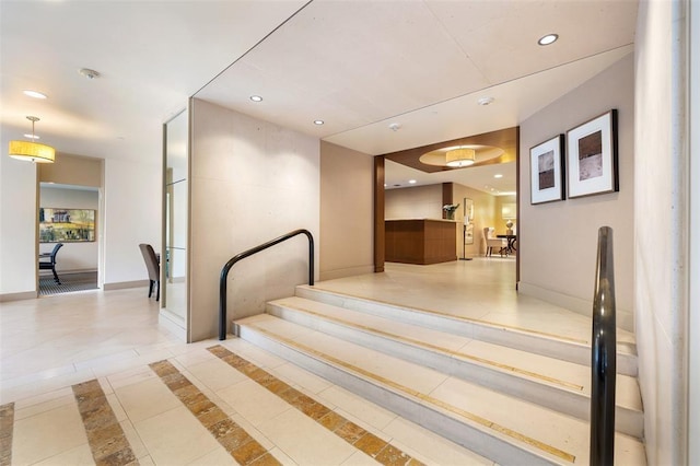 stairway featuring tile patterned flooring