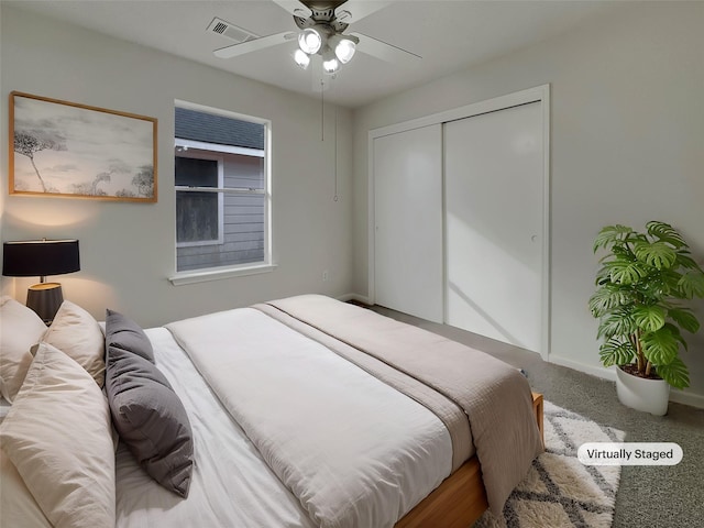 carpeted bedroom with ceiling fan and a closet