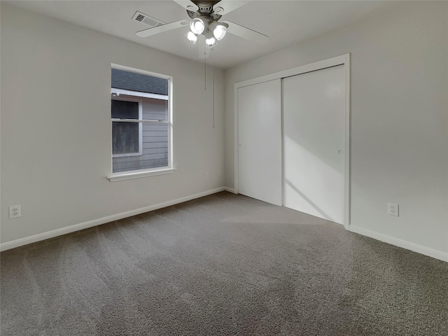 interior space with carpet floors and ceiling fan