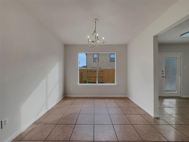 unfurnished dining area featuring light tile patterned floors and an inviting chandelier