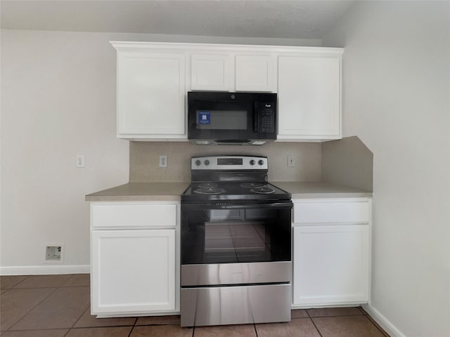 kitchen featuring white cabinetry, tile patterned floors, and stainless steel range with electric stovetop