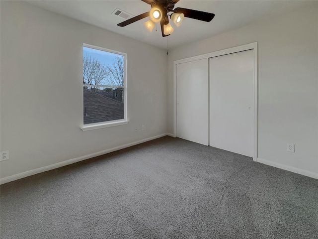 unfurnished bedroom with carpet, a closet, and ceiling fan