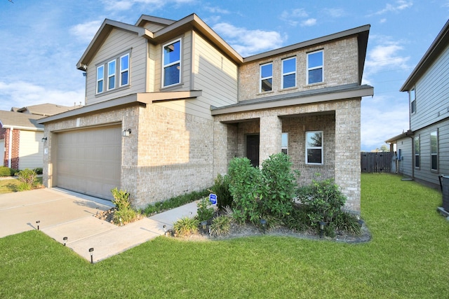 view of front of home with a front yard and a garage