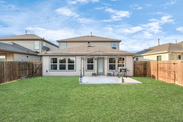 back of property featuring a gazebo, a patio area, and a lawn