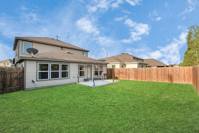 rear view of property with a patio and a yard