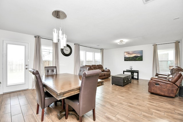 dining space with light hardwood / wood-style floors