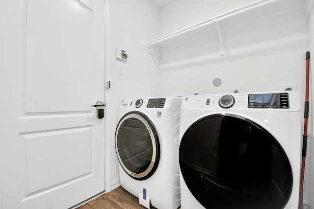 washroom featuring wood-type flooring and washer and dryer