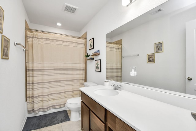 bathroom with toilet, tile patterned flooring, and vanity