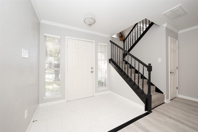 foyer featuring ornamental molding