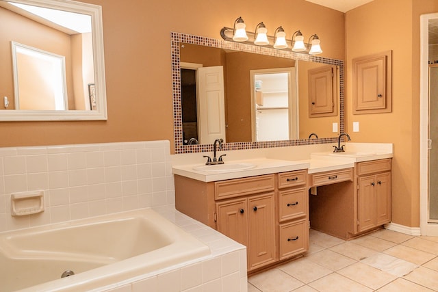 bathroom with tiled bath, tile patterned flooring, and vanity