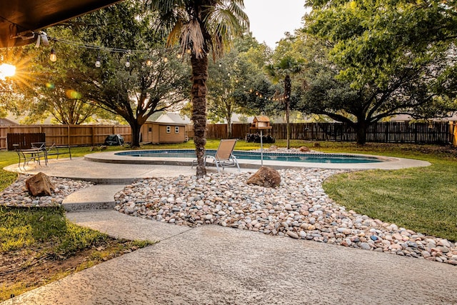 view of swimming pool with a lawn and a patio