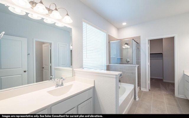 bathroom featuring independent shower and bath, tile patterned floors, and vanity