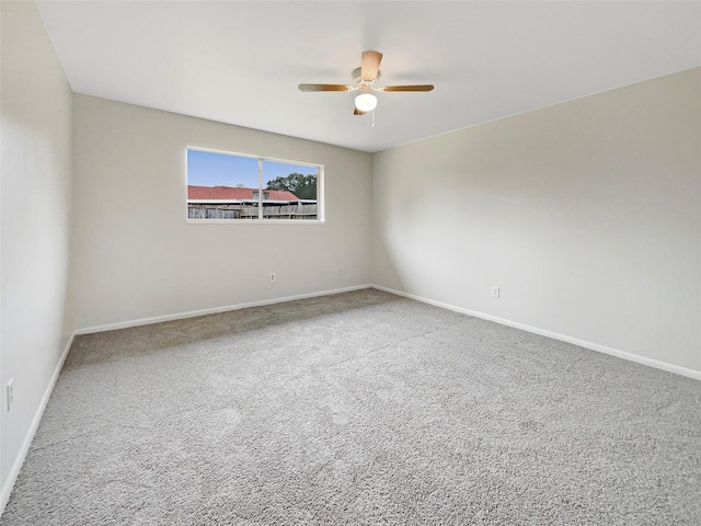 carpeted empty room featuring ceiling fan