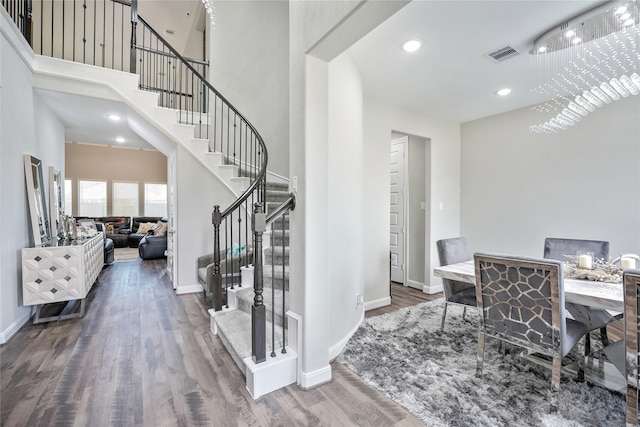 interior space featuring dark hardwood / wood-style floors and a towering ceiling