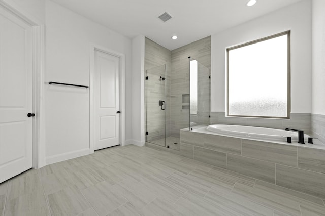 full bathroom with visible vents, a garden tub, a shower stall, and recessed lighting