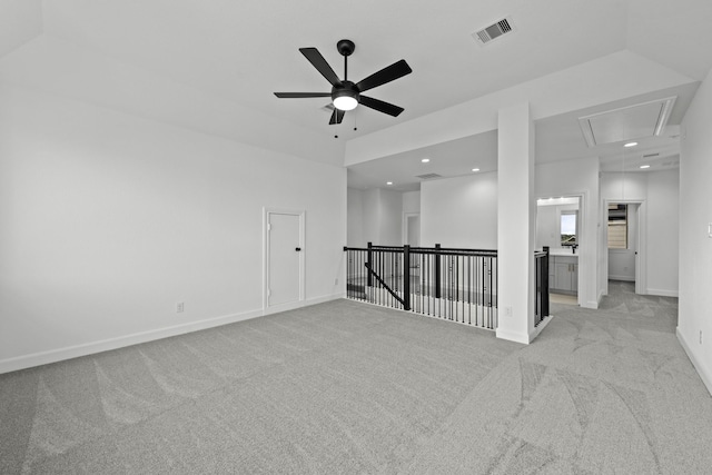 unfurnished room with recessed lighting, light colored carpet, visible vents, baseboards, and attic access