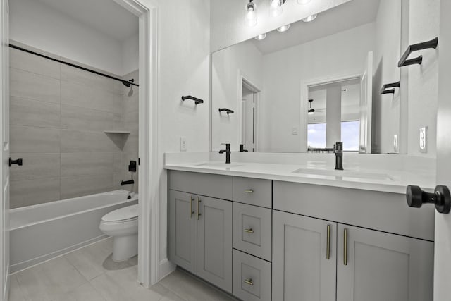 full bath with double vanity, bathtub / shower combination, a sink, and toilet