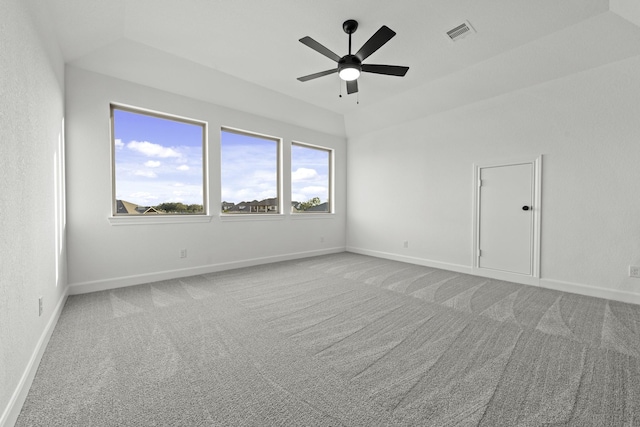 carpeted spare room featuring visible vents, ceiling fan, and baseboards