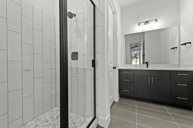 bathroom with ceiling fan, a stall shower, tile patterned flooring, and vanity