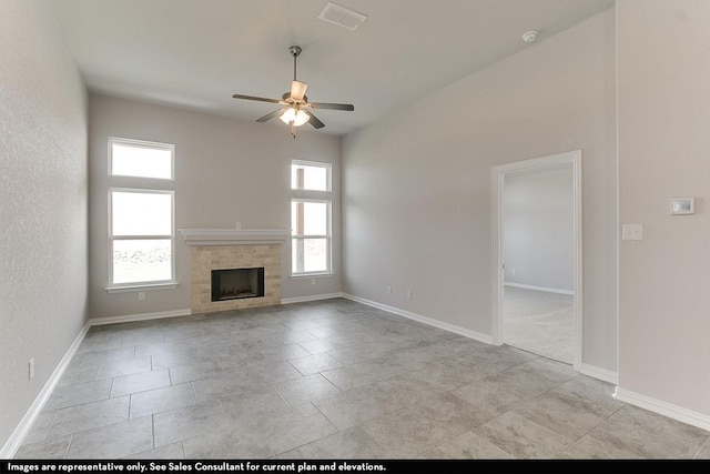 unfurnished living room with ceiling fan and a fireplace