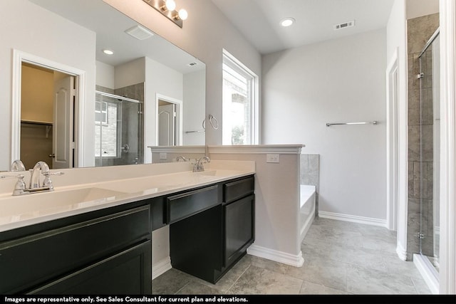 bathroom featuring separate shower and tub, vanity, and tile patterned floors