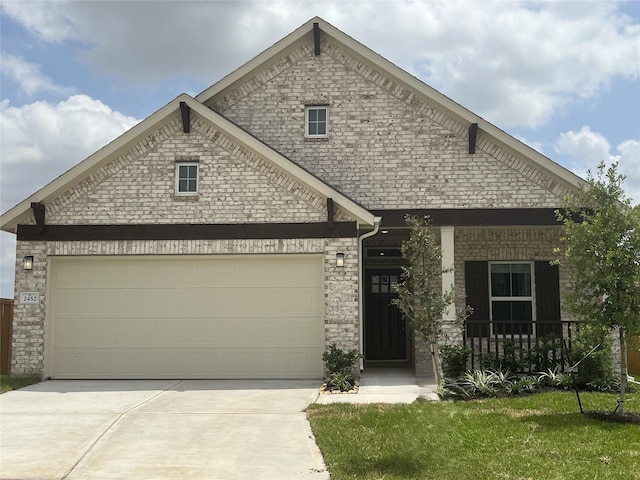 view of front of home featuring a garage, covered porch, driveway, and stone siding