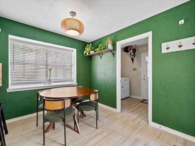 dining space with washer / dryer and a textured ceiling