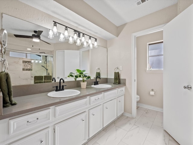 bathroom with toilet, vanity, ceiling fan, and walk in shower