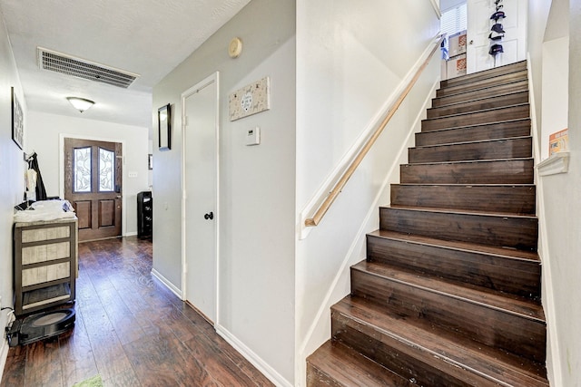 staircase with wood-type flooring