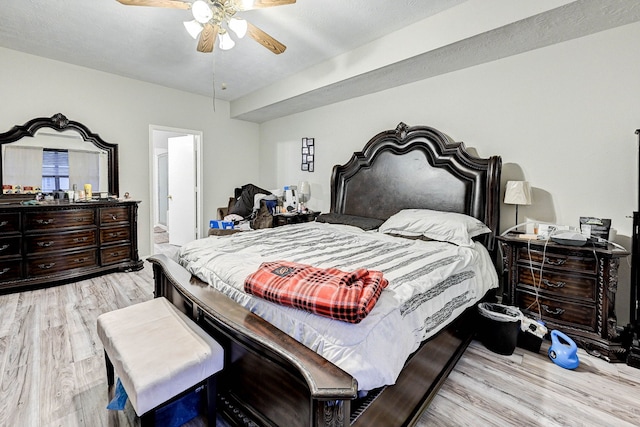 bedroom featuring ceiling fan, connected bathroom, and light wood-type flooring