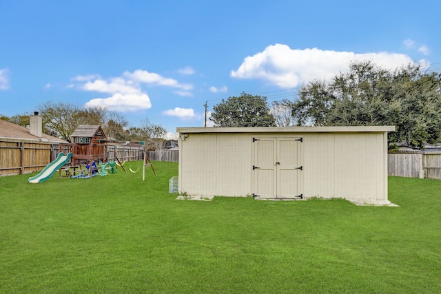 view of outbuilding with a playground and a lawn