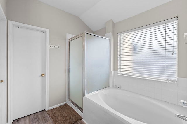 1711 Village Court Ln, Rosenberg, TX 77471 - bathroom featuring a bath, vaulted ceiling, wood finished floors, and a stall shower