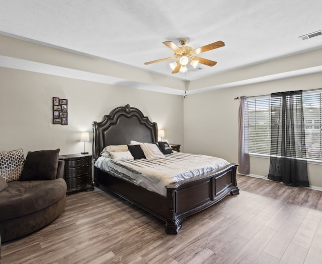 1711 Village Court Ln, Rosenberg, TX 77471 - bedroom featuring ceiling fan, baseboards, wood finished floors, and visible vents