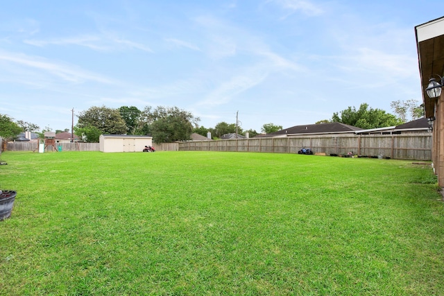 1711 Village Court Ln, Rosenberg, TX 77471 - view of yard featuring a fenced backyard, an outdoor structure, a shed, and a playground
