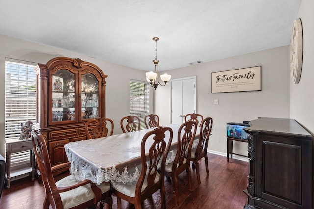1711 Village Court Ln, Rosenberg, TX 77471 - dining room featuring a notable chandelier, baseboards, dark wood-style flooring, and visible vents