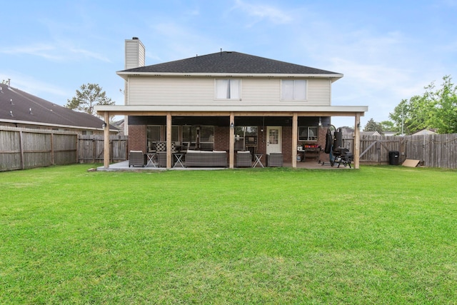 1711 Village Court Ln, Rosenberg, TX 77471 - back of property featuring brick siding, a lawn, a fenced backyard, and a patio