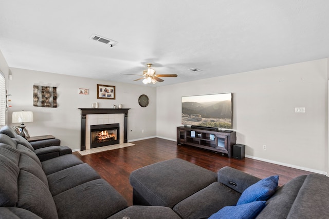 1711 Village Court Ln, Rosenberg, TX 77471 - living area with wood finished floors, a tiled fireplace, a ceiling fan, and visible vents