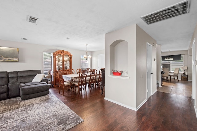 1711 Village Court Ln, Rosenberg, TX 77471 - living area featuring hardwood / wood-style floors, visible vents, arched walkways, and a notable chandelier