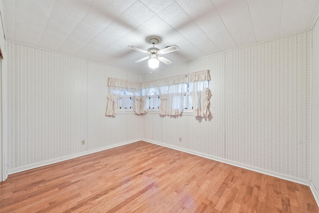 spare room with ceiling fan and wood-type flooring