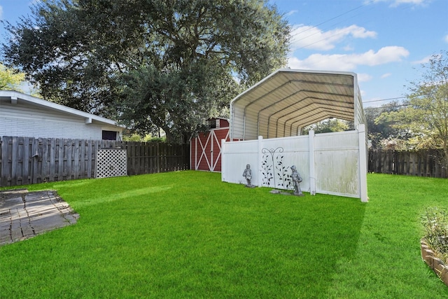 view of yard with a storage shed and a carport